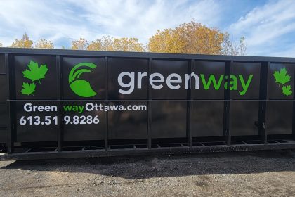 Black Greenway Ottawa roll-off dumpster in an outdoor yard